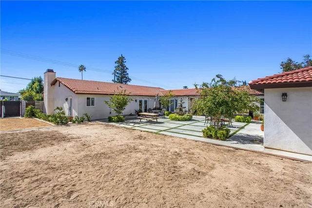 a living room with furniture a flat screen tv and a floor to ceiling window
