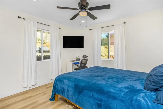 a living room with a bed and a window