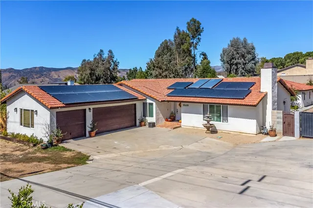 an aerial view of residential houses with outdoor space and river