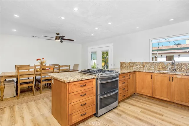 a kitchen with stainless steel appliances granite countertop a stove and a sink