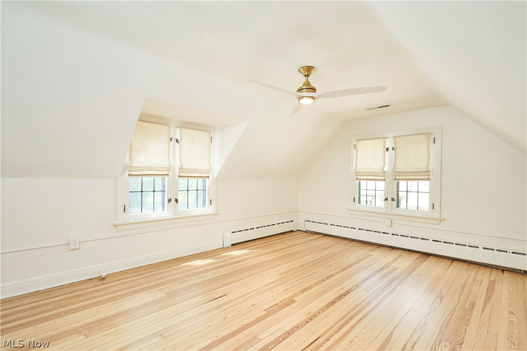 644 Ridgecrest Road Akron, OH 44303 - Photo 35 of 47 Room featuring sloped ceilings, two dormer windows, natural wood-finish flooring, and a ceiling fan with integrated lighting