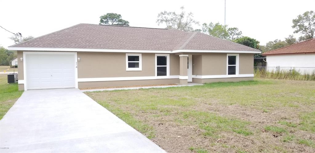 14 Spring Track Ocala, FL 34472 - Photo 1 of 1 a front view of a house with a yard and garage