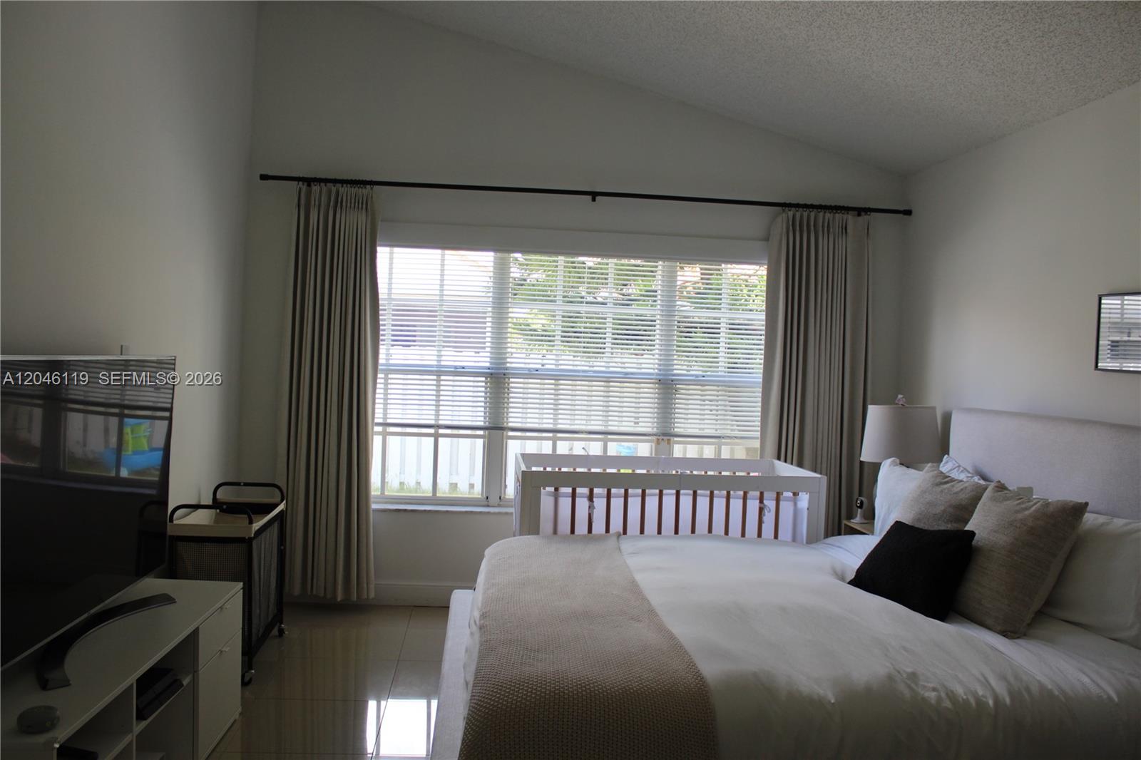312 Bridgeton Road Weston, FL 33326 - Photo 2 of 13 a bedroom with a bed and wooden floor