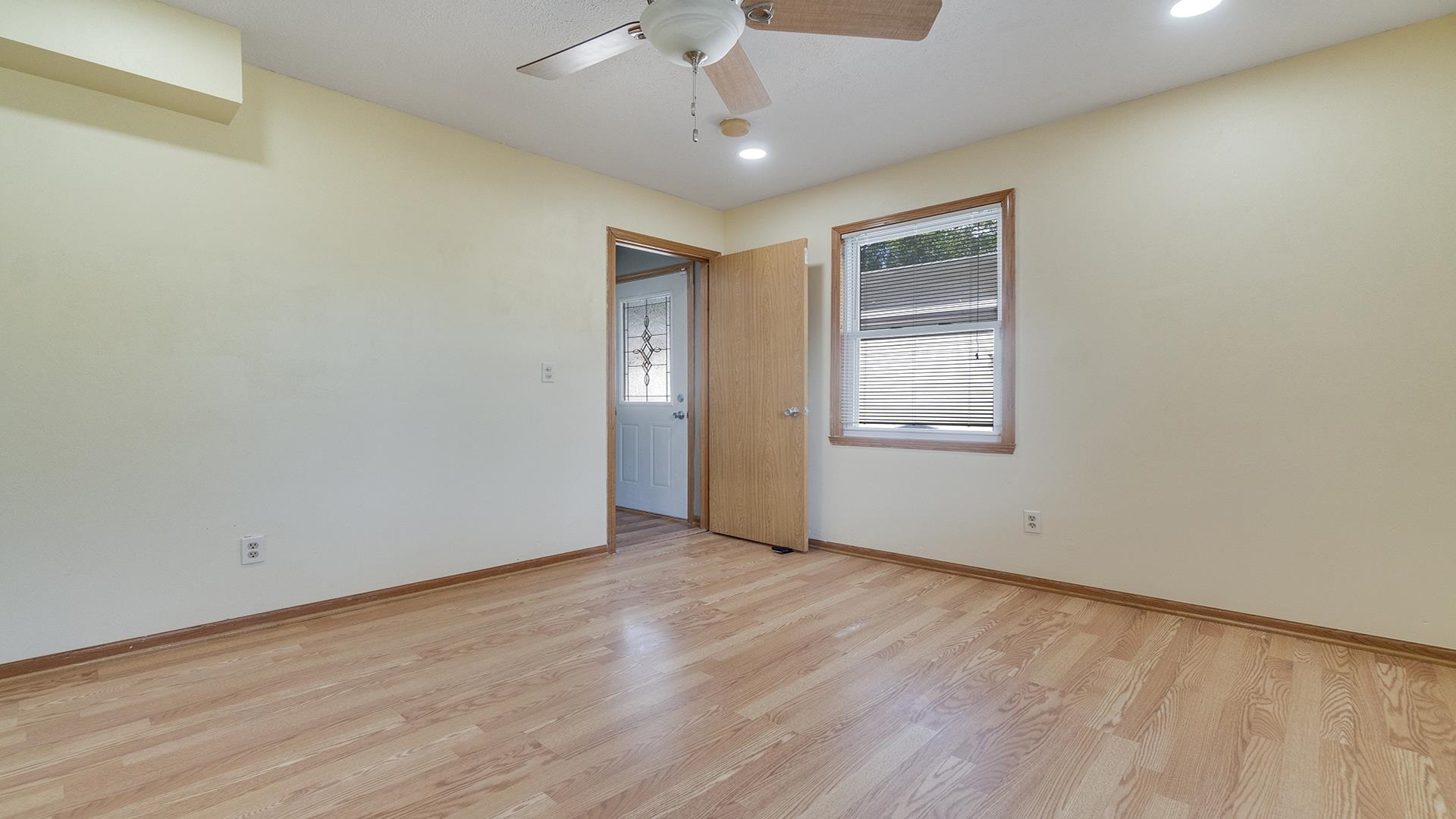 820 East Riverside Boulevard Loves Park, IL 61111 - Photo 13 of 32 a view of an empty room with wooden floor and a window
