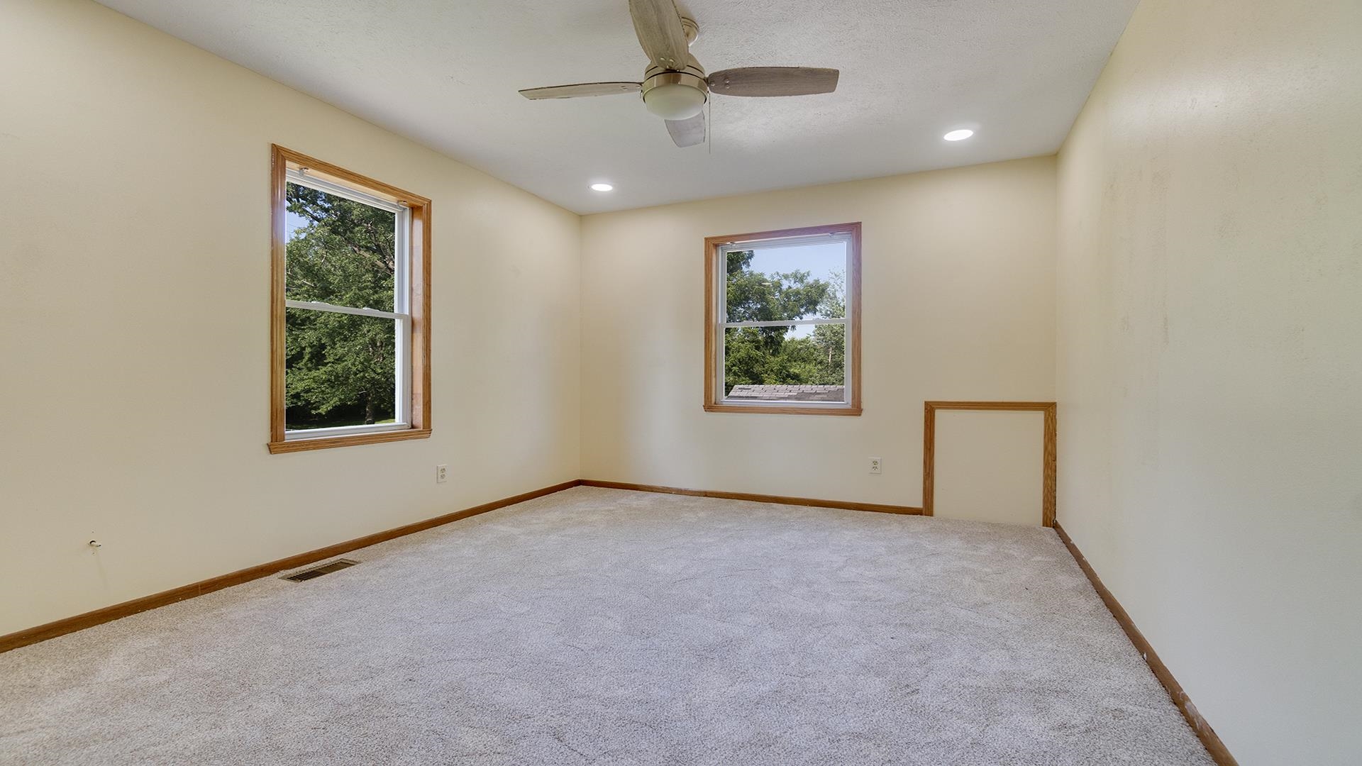 820 East Riverside Boulevard Loves Park, IL 61111 - Photo 17 of 32 an empty room with windows and ceiling fan