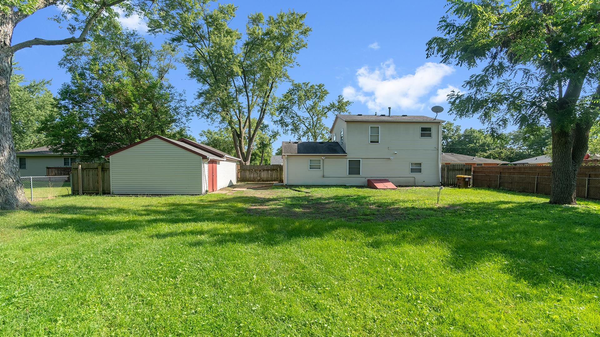 820 East Riverside Boulevard Loves Park, IL 61111 - Photo 24 of 32 a view of a house with backyard and a tree