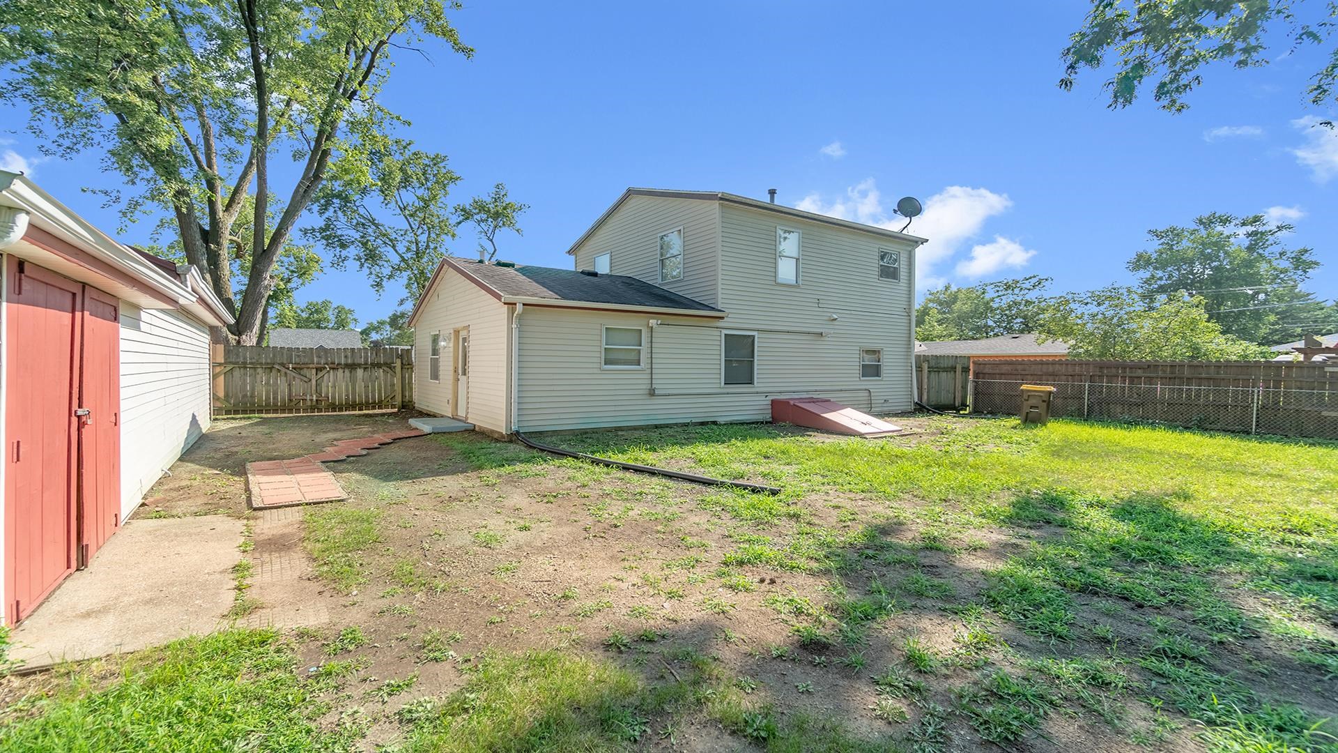 820 East Riverside Boulevard Loves Park, IL 61111 - Photo 26 of 32 a backyard of a house with table and chairs