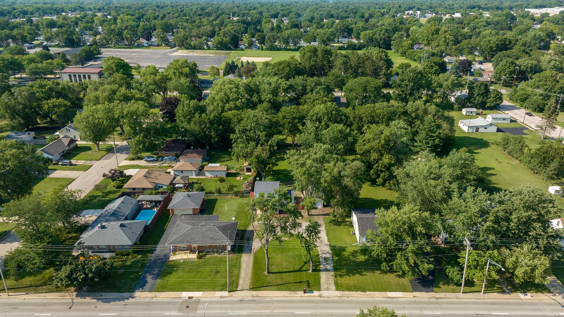 820 East Riverside Boulevard Loves Park, IL 61111 - Photo 31 of 32 an aerial view of a house with a yard and lake view