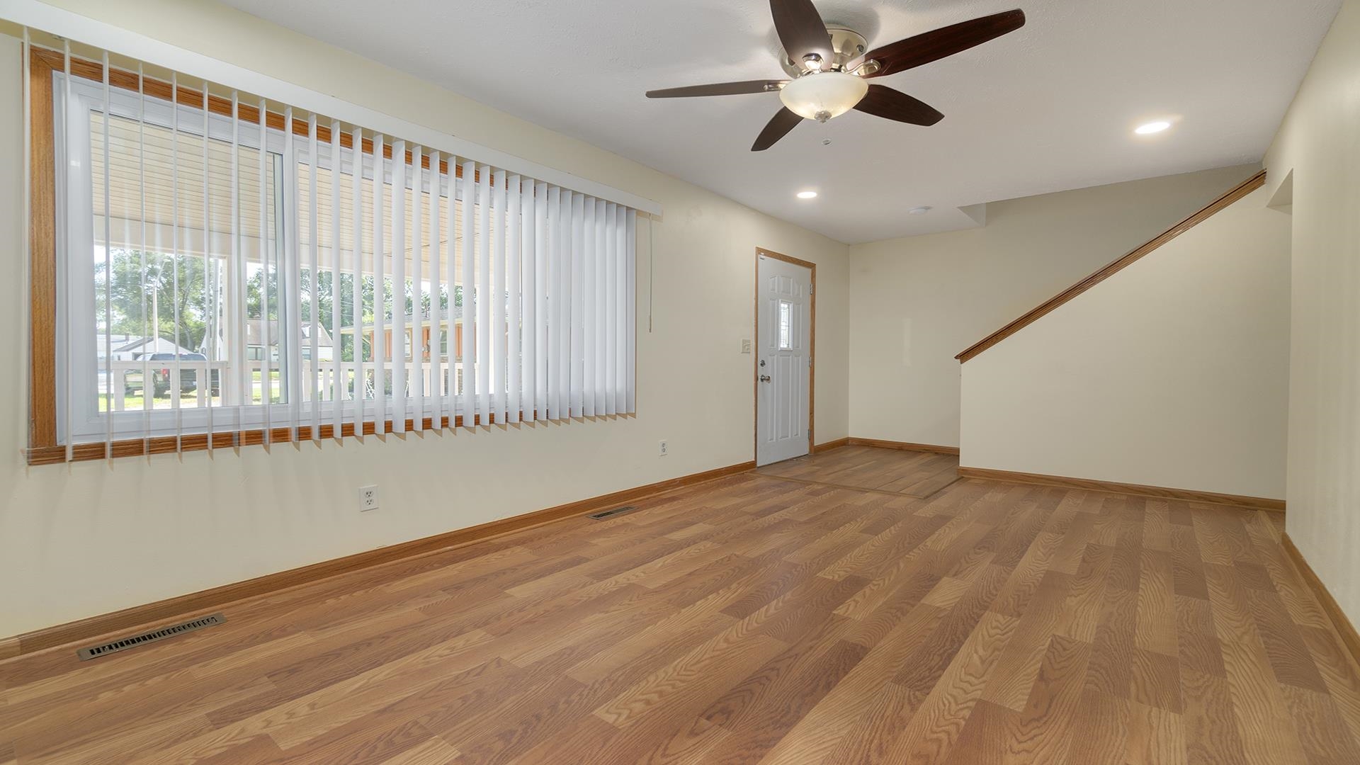 820 East Riverside Boulevard Loves Park, IL 61111 - Photo 6 of 32 a view of an empty room with a window and wooden floor