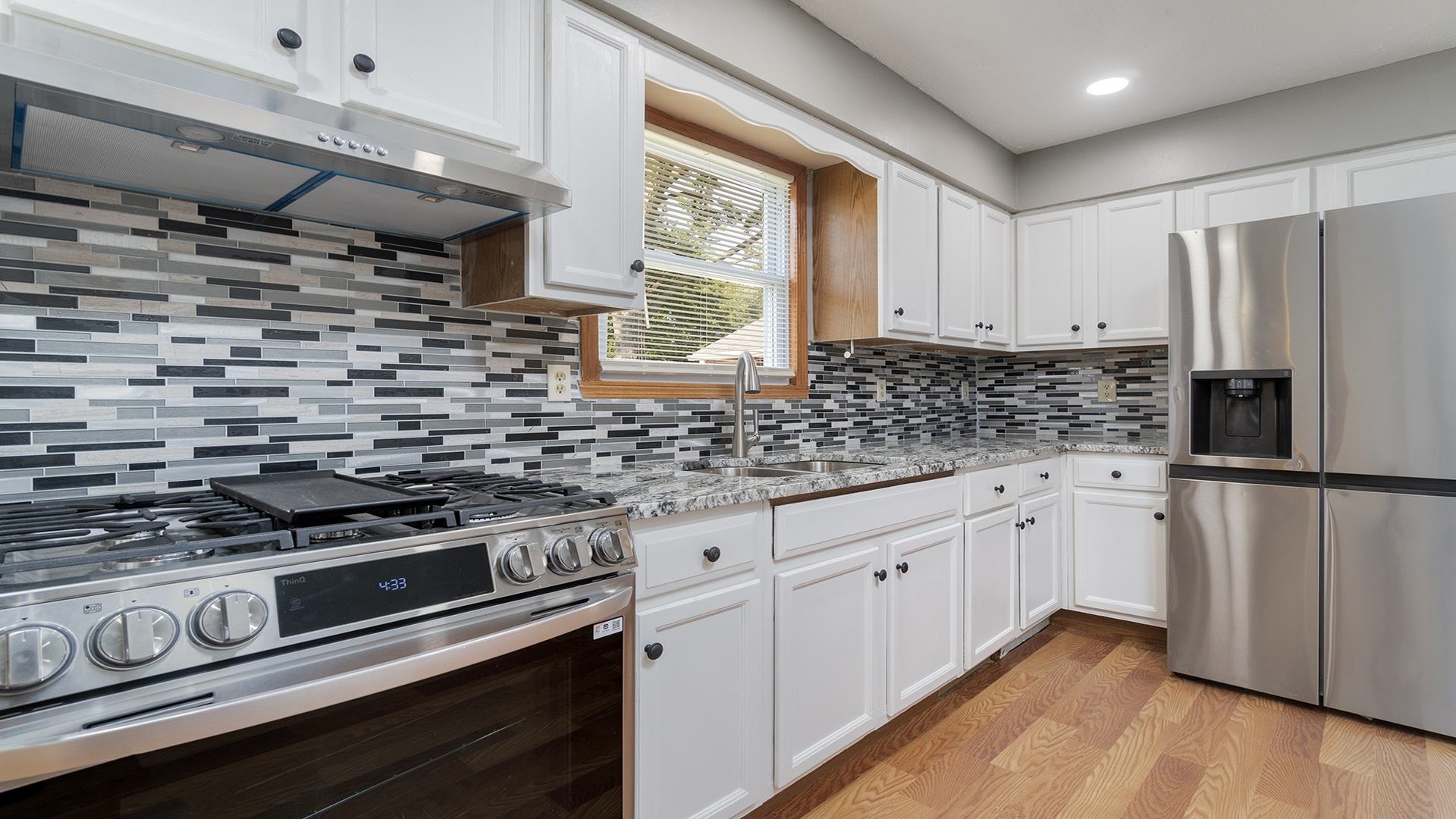 820 East Riverside Boulevard Loves Park, IL 61111 - Photo 10 of 32 a kitchen with stainless steel appliances a stove a refrigerator and cabinets