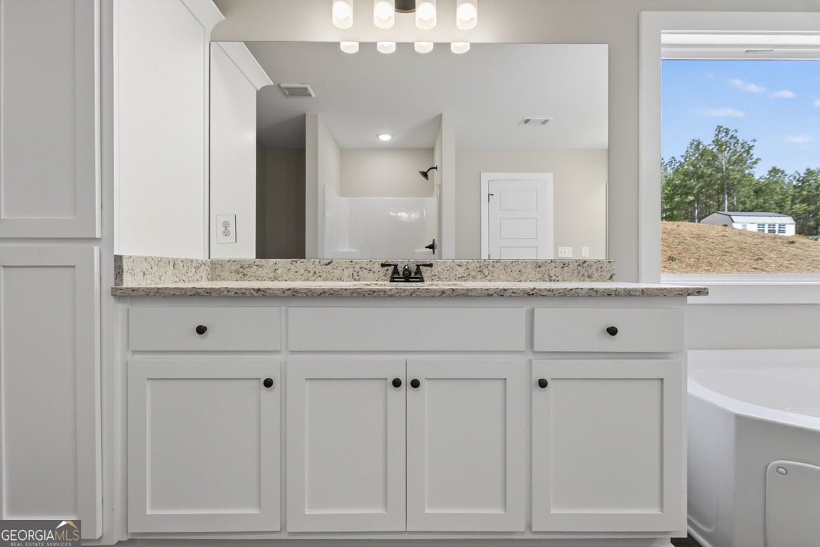 97 Wards Creek Road, Unit 1 Toccoa, GA 30577 - Photo 28 of 55 a bathroom with a granite countertop sink vanity and mirror