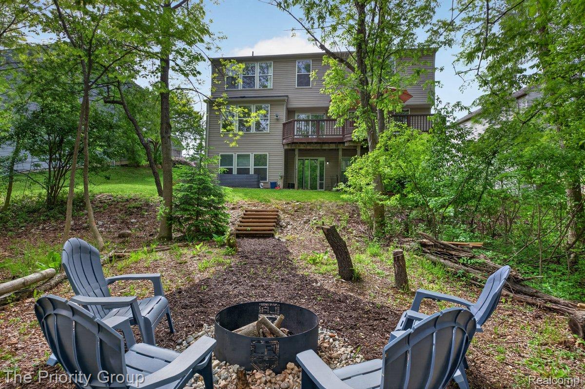 517 Deer Valley Road Holly, MI 48442 - Photo 48 of 61 Back of house with an outdoor fire pit