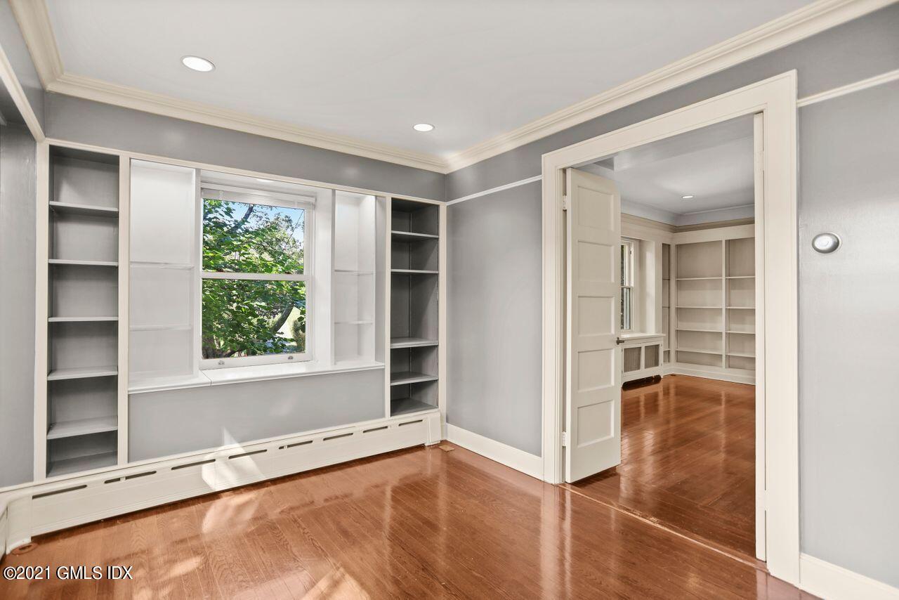 27 Sachem Road Greenwich, CT 06830 - Photo 13 of 50 a view of an empty room with a window and wooden floor