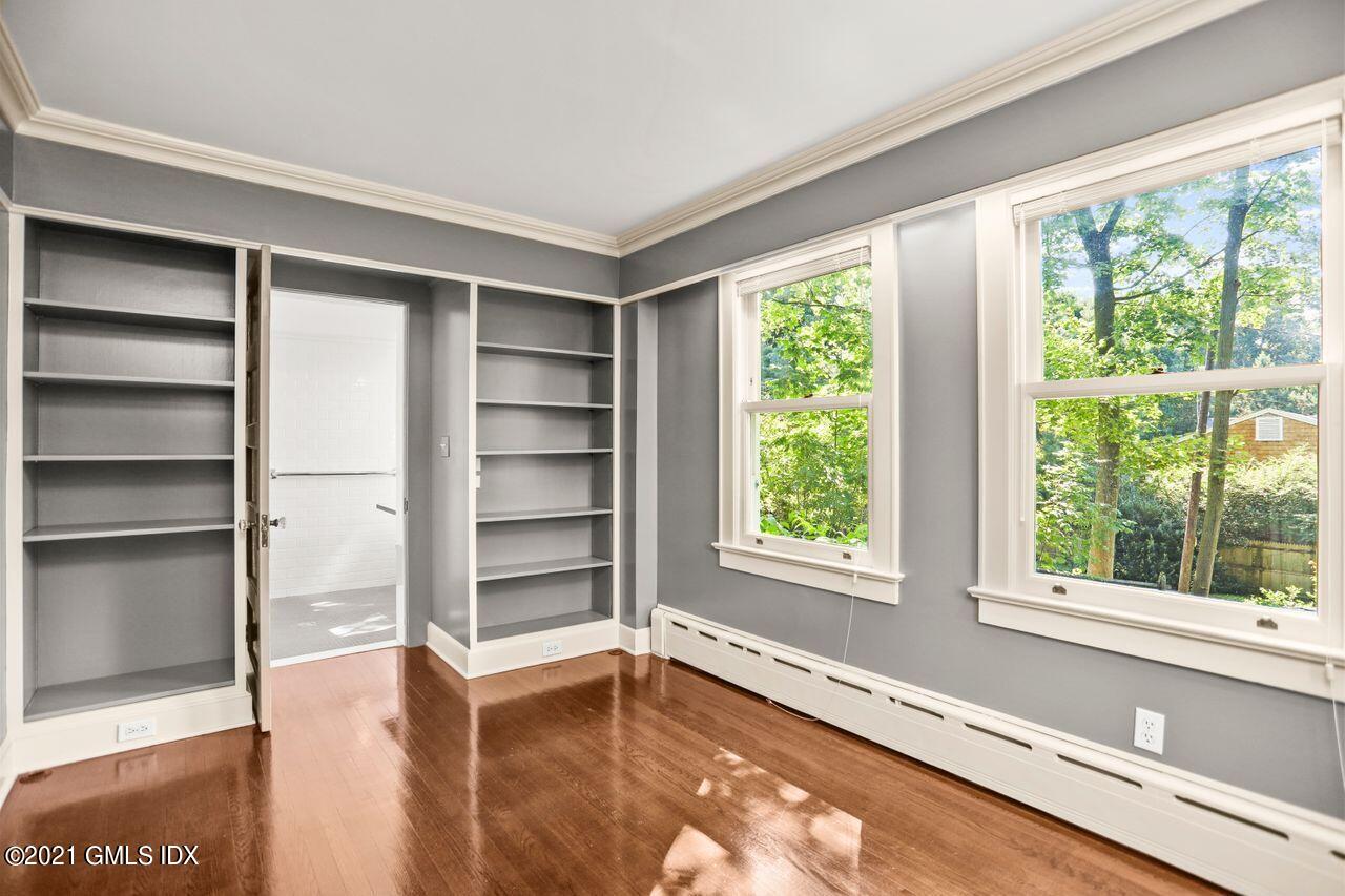 27 Sachem Road Greenwich, CT 06830 - Photo 14 of 50 a view of an empty room with a window and wooden floor