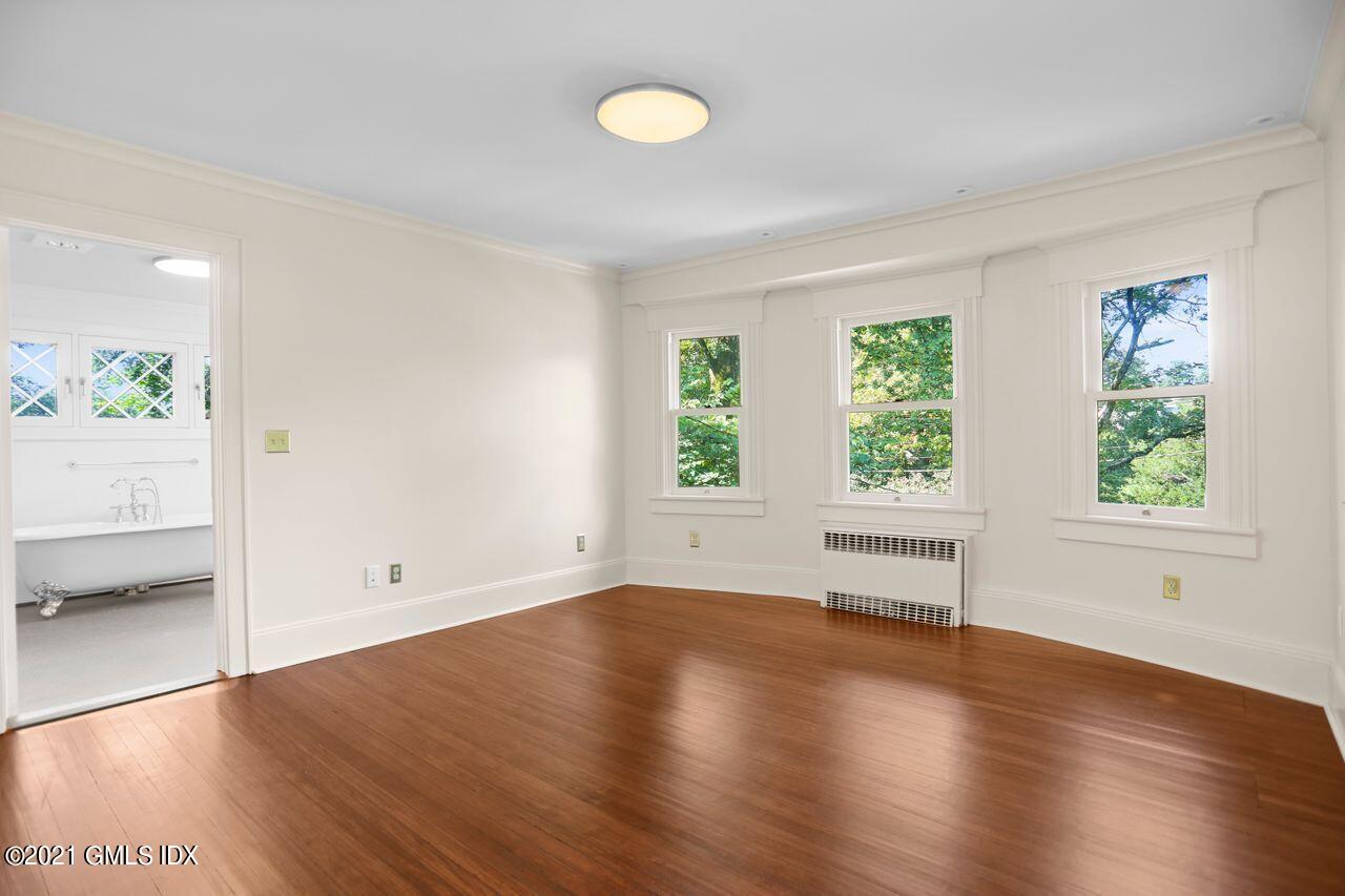 27 Sachem Road Greenwich, CT 06830 - Photo 18 of 50 an empty room with wooden floor and windows