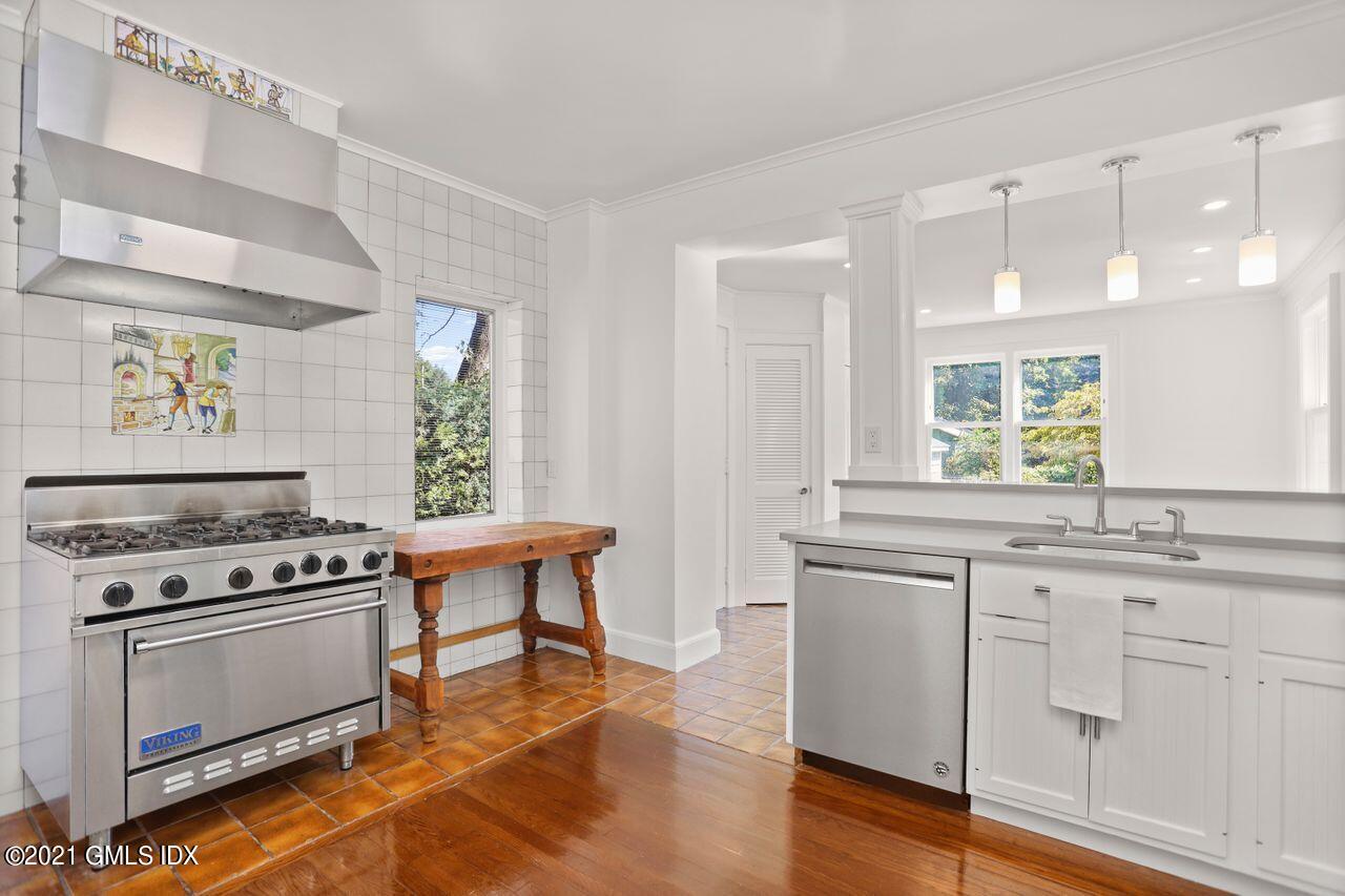 27 Sachem Road Greenwich, CT 06830 - Photo 2 of 50 a kitchen with granite countertop a stove a sink and a refrigerator