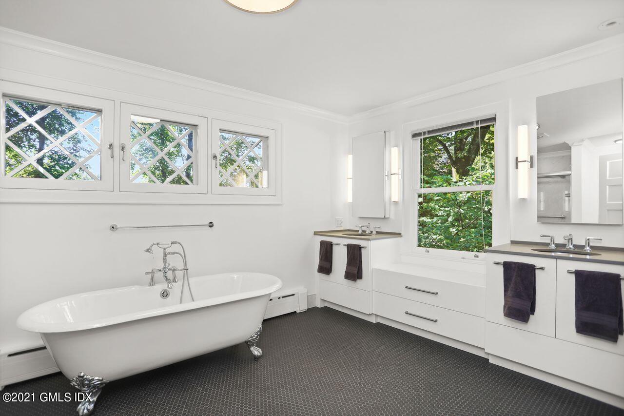27 Sachem Road Greenwich, CT 06830 - Photo 21 of 50 a white bed sitting in a room next to a window