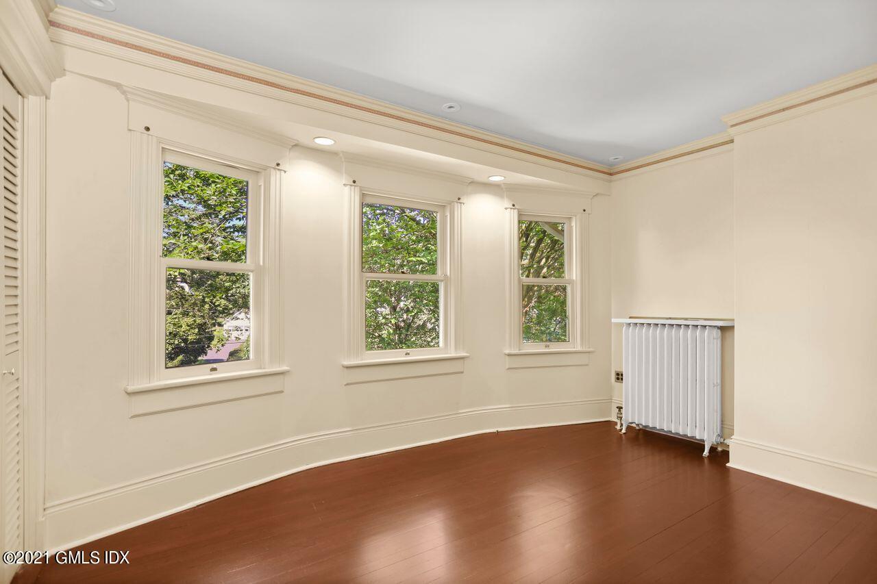 27 Sachem Road Greenwich, CT 06830 - Photo 23 of 50 an empty room with wooden floor and windows