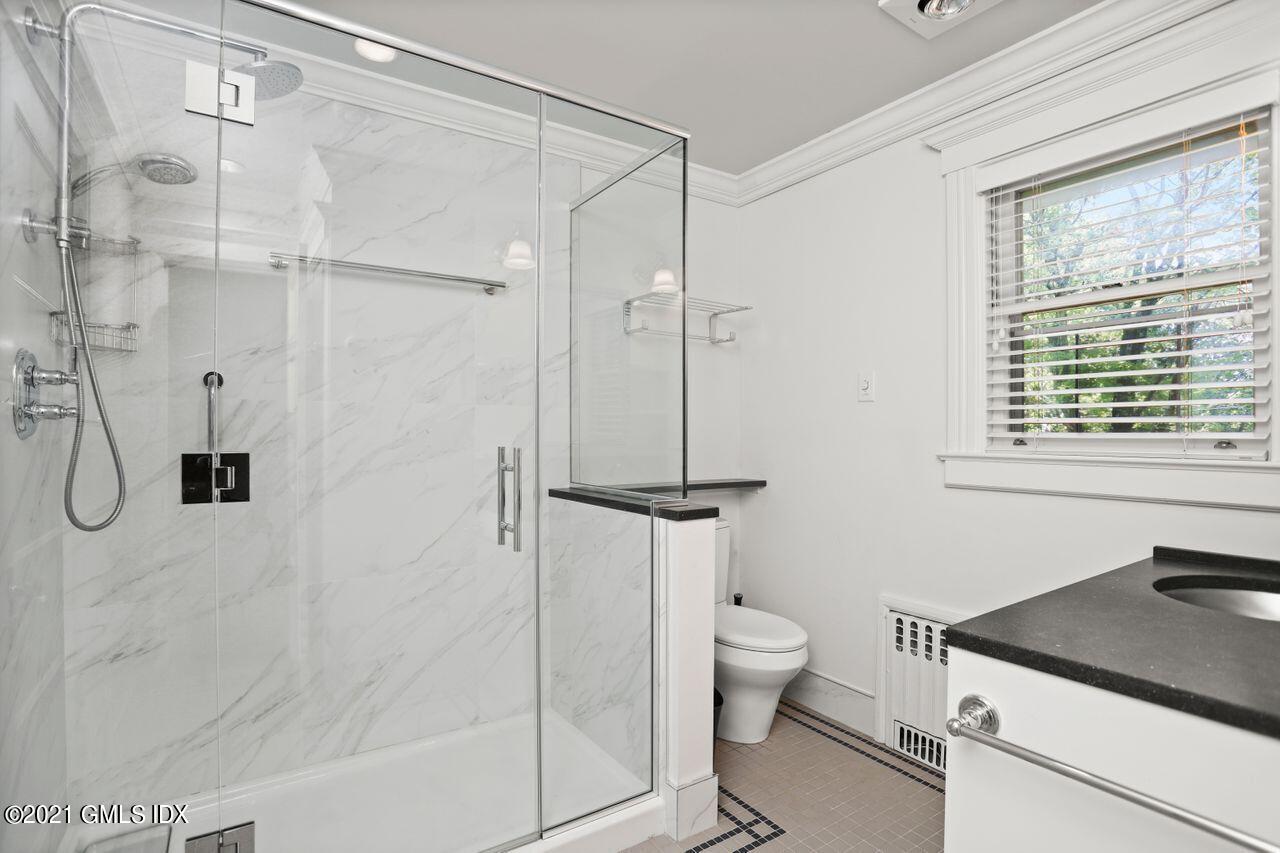 27 Sachem Road Greenwich, CT 06830 - Photo 25 of 50 a bathroom with a granite countertop sink a toilet and shower