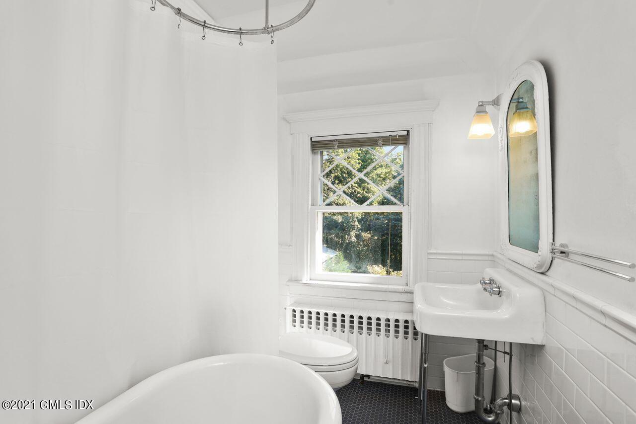 27 Sachem Road Greenwich, CT 06830 - Photo 28 of 50 a bathroom with a sink and a mirror
