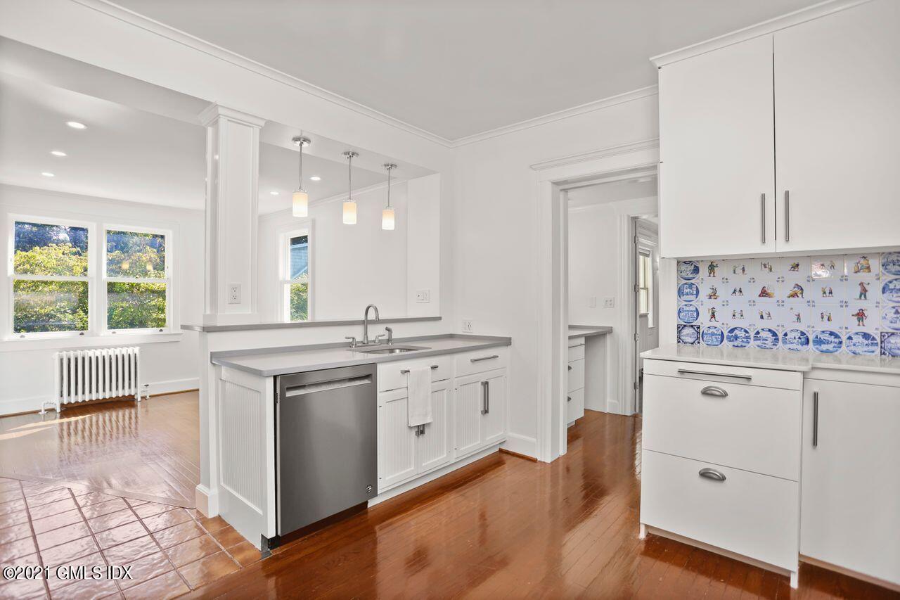 27 Sachem Road Greenwich, CT 06830 - Photo 3 of 50 a kitchen with granite countertop white cabinets and white appliances
