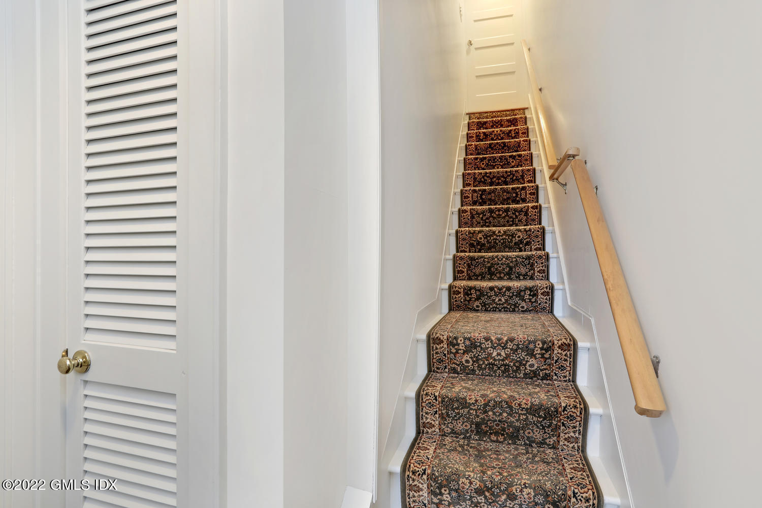 27 Sachem Road Greenwich, CT 06830 - Photo 40 of 50 a view of a hallway with stairs and wooden floor