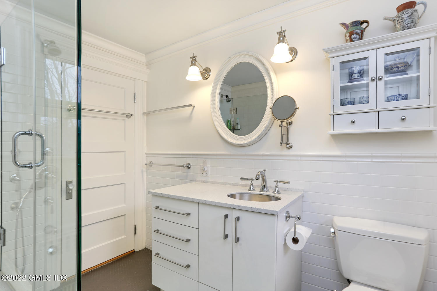 27 Sachem Road Greenwich, CT 06830 - Photo 44 of 50 a bathroom with a sink vanity mirror and toilet