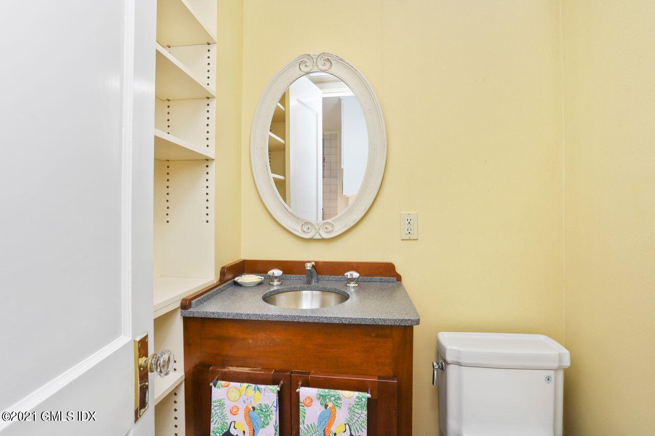 27 Sachem Road Greenwich, CT 06830 - Photo 9 of 50 a bathroom with a sink and a mirror