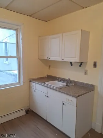 a kitchen with a sink window and cabinets