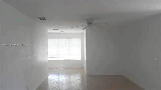 a view of an empty room and a window