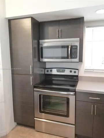 a kitchen with a stove and a microwave