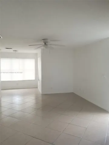 a view of an empty room and a window