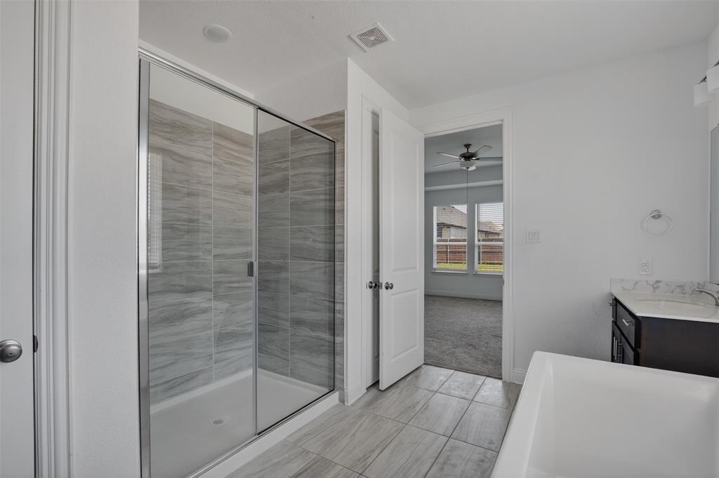 845 Ranchland Road Justin, TX 76247 - Photo 18 of 22 a bathroom with a shower and closet