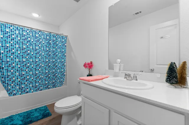 a bedroom with toys and a wooden floor