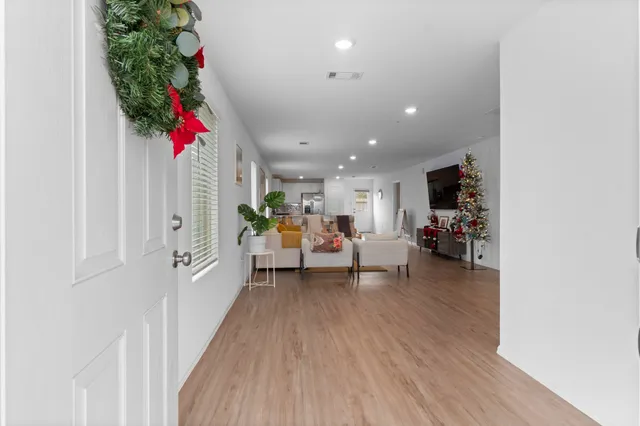 a living room with furniture and a potted plant