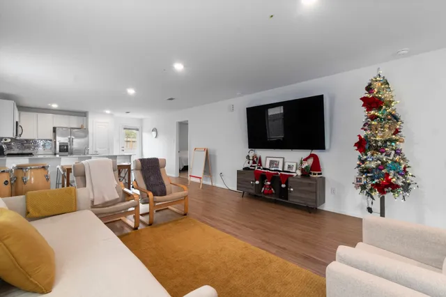 a living room with furniture flowers and a potted plant