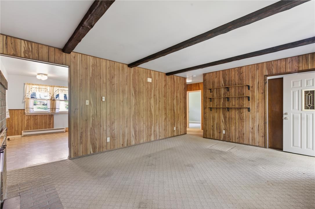 18 White Oak Road Nesquehoning, PA 18240 - Photo 15 of 52 Warm wood paneling and exposed ceiling beams create a rustic and inviting atmosphere.