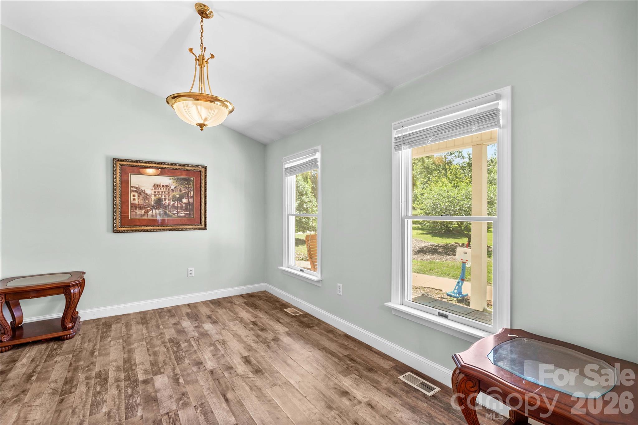 711 Spring Pointe Drive Stony Point, NC 28678 - Photo 12 of 47 a view of a livingroom with a window and wooden floor