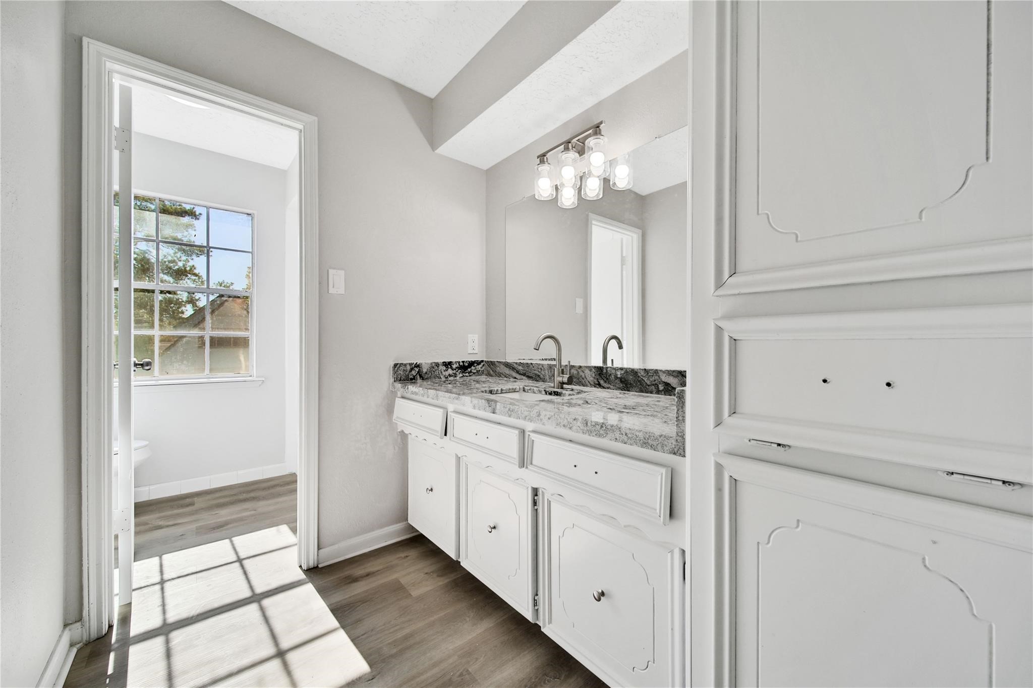 13426 Balcrest Drive Houston, TX 77070 - Photo 15 of 22 a bathroom with a granite countertop sink and a mirror