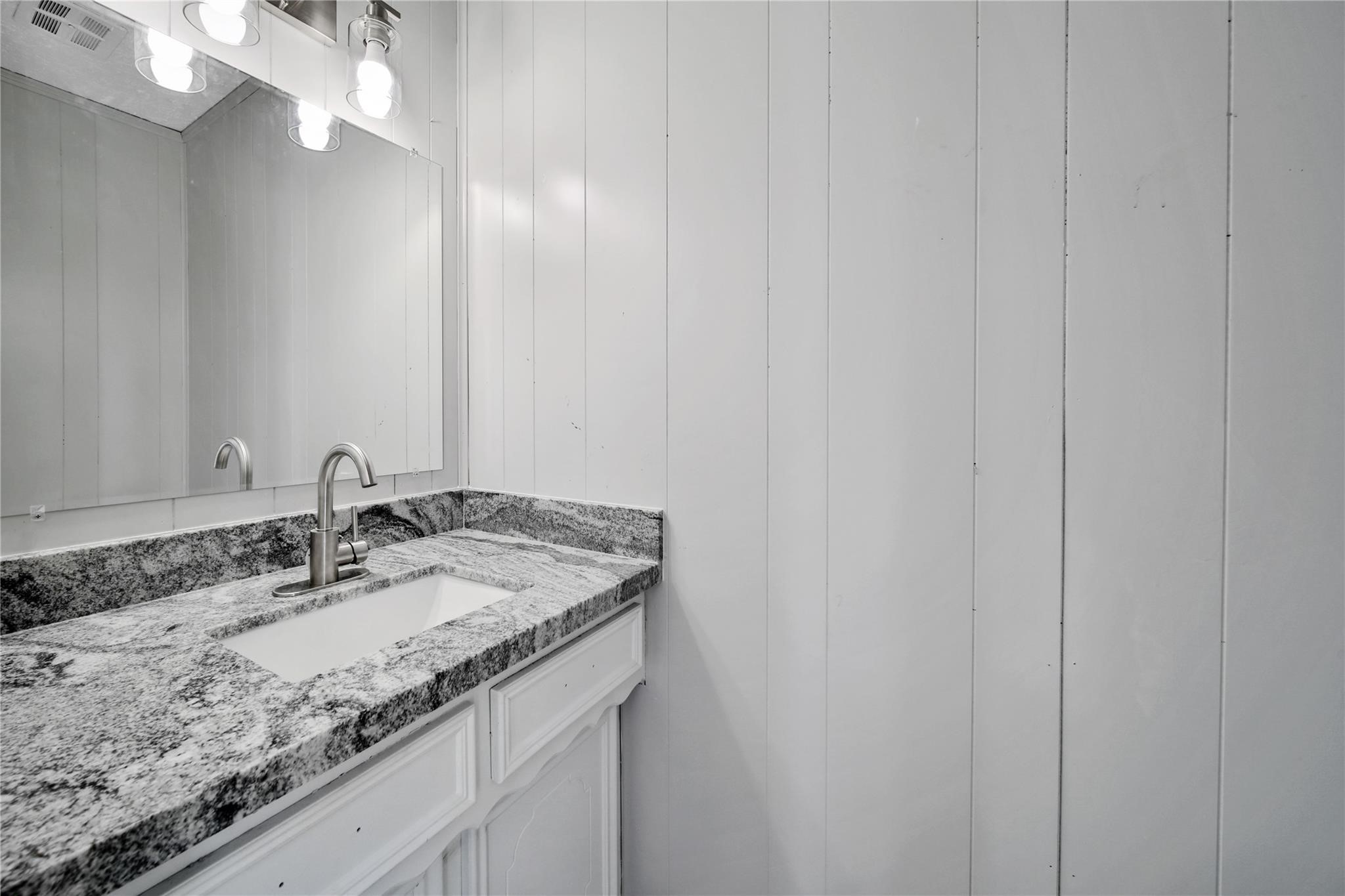 13426 Balcrest Drive Houston, TX 77070 - Photo 19 of 22 a bathroom with a granite countertop sink and a mirror