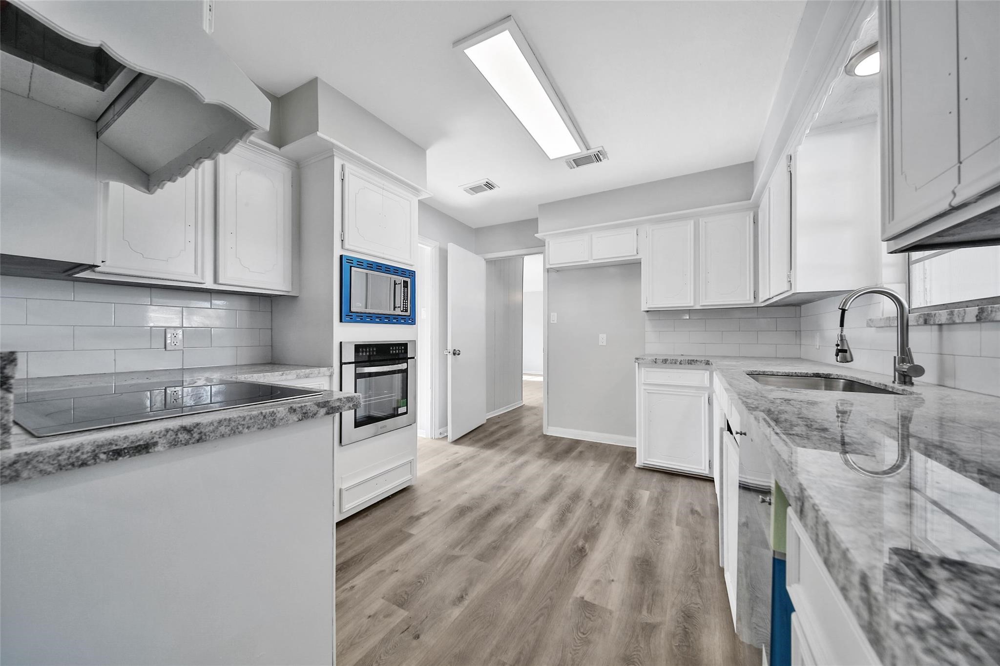 13426 Balcrest Drive Houston, TX 77070 - Photo 9 of 22 a kitchen with granite countertop a sink stainless steel appliances and cabinets