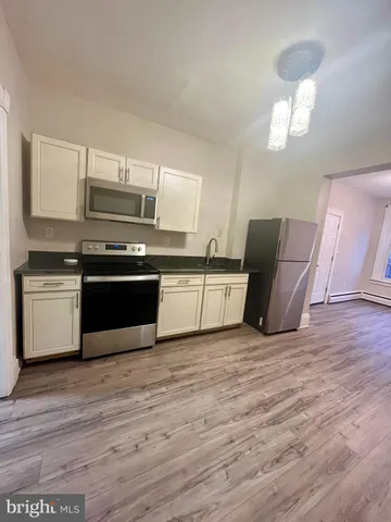 a kitchen with wooden cabinets and stainless steel appliances