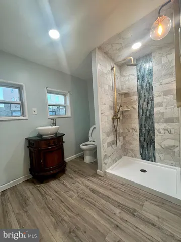 a living room with a couch and a wooden floor