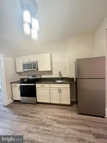 a kitchen with a refrigerator and a sink