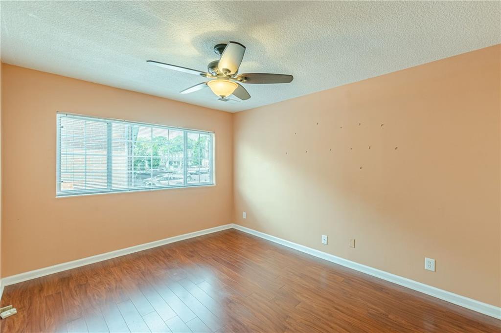 1705 Monroe Drive Northeast, Unit C05 Atlanta, GA 30324 - Photo 11 of 29 an empty room with wooden floor and windows