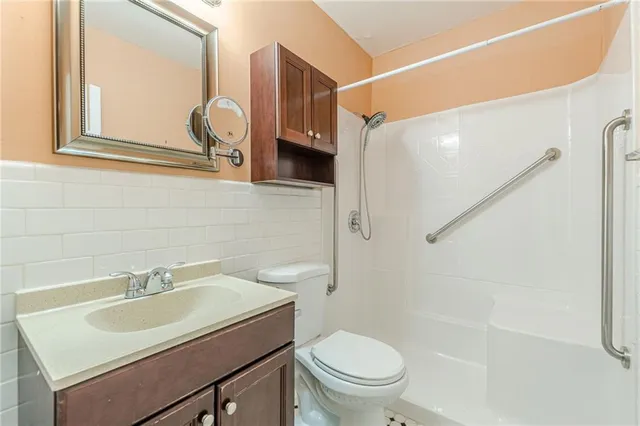 a bathroom with a sink toilet and shower