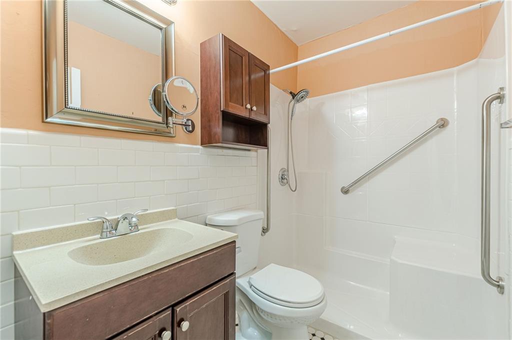 1705 Monroe Drive Northeast, Unit C05 Atlanta, GA 30324 - Photo 12 of 29 a bathroom with a sink toilet and shower