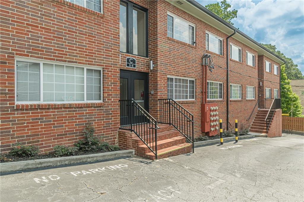 1705 Monroe Drive Northeast, Unit C05 Atlanta, GA 30324 - Photo 3 of 29 a view of a house with a floor to ceiling windows and a basket ball poll