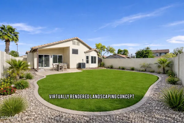 a view of a house with a backyard