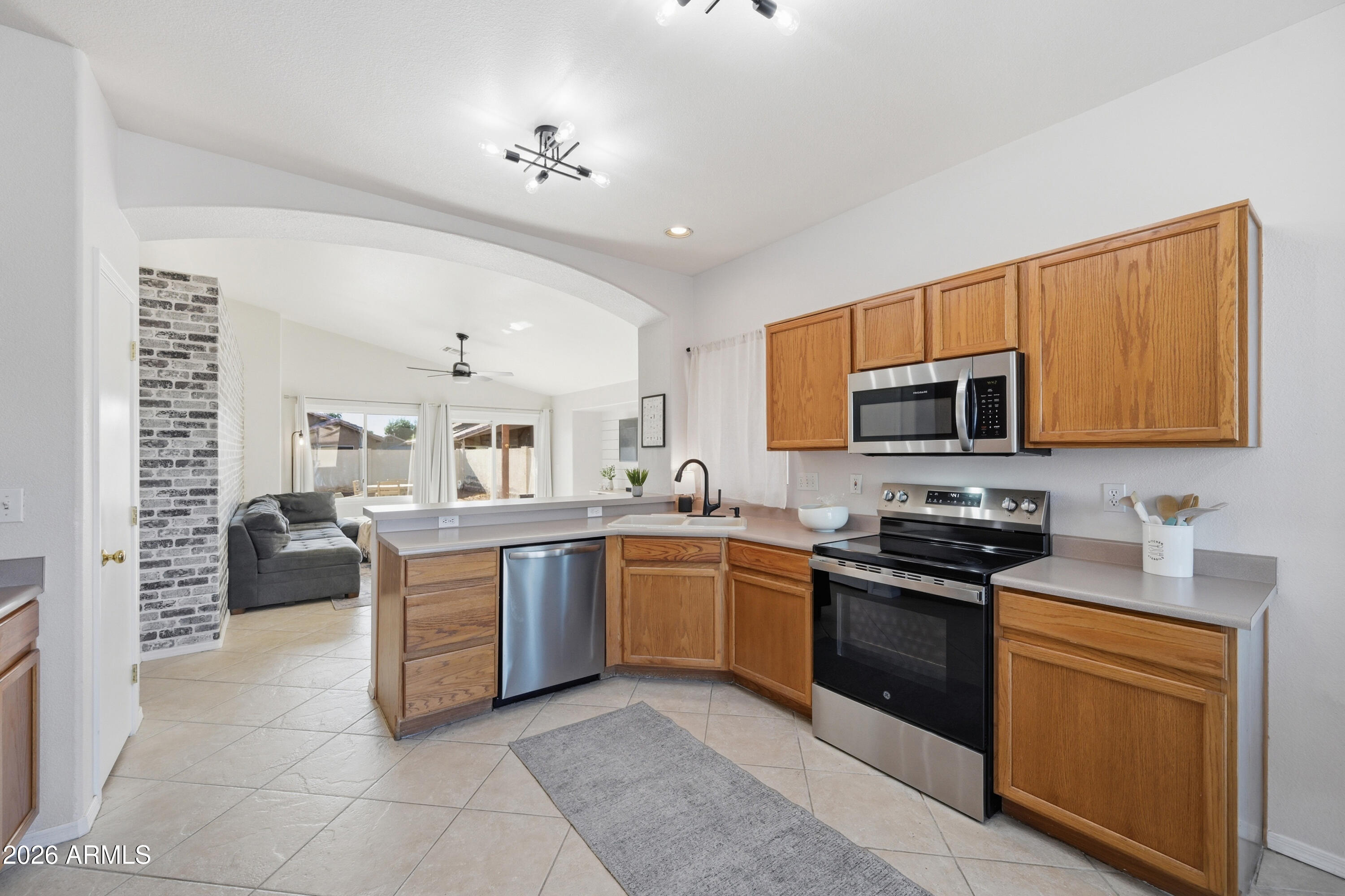 1994 South Spartan Street Gilbert, AZ 85233 - Photo 5 of 30 a kitchen with stainless steel appliances granite countertop a stove top oven a sink dishwasher and a refrigerator